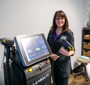 A woman standing next to a machine in a room.