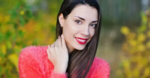 A woman with long hair and red lipstick.