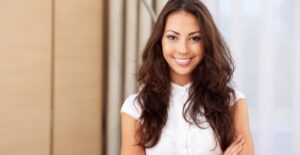 A woman with long hair smiles for the camera.