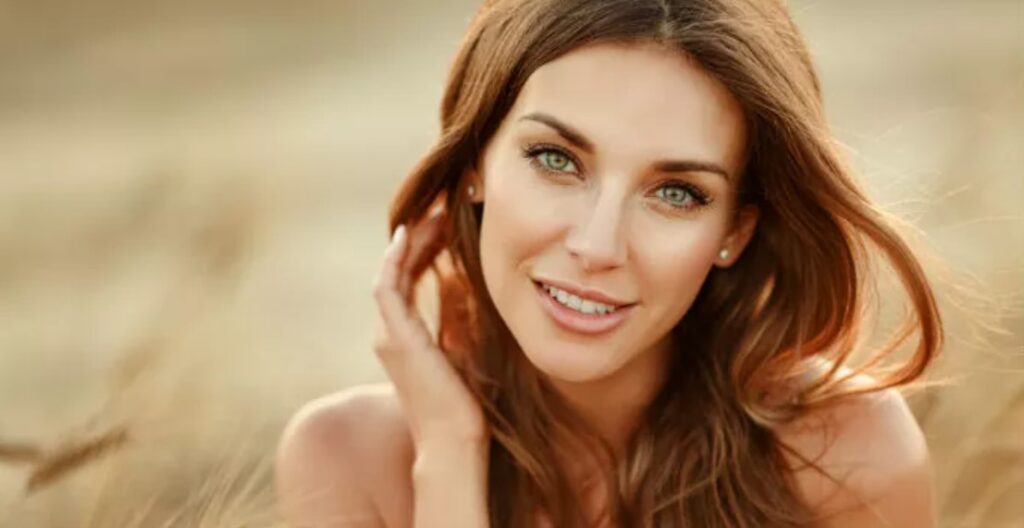 A beautiful woman with long brown hair and green eyes.