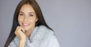 A woman with long hair and a white sweater.