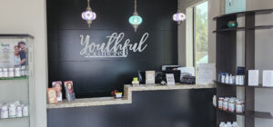 A black wall with the words youthful dentistry written on it.