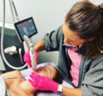 A woman is getting her teeth cleaned by an esthetician.