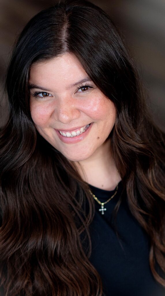 Smiling woman with long brown hair.